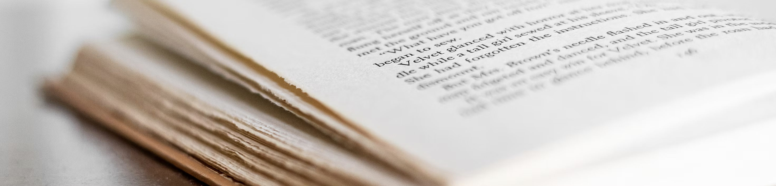 A wide image of an open book.